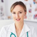 portrait-of-smiling-female-doctor-in-her-doctor-s-2021-08-27-16-32-51-utc-1